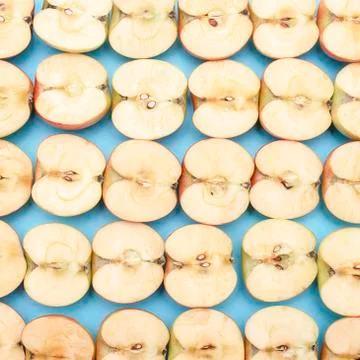 Background of cut in half apples on blue background Stock Photos