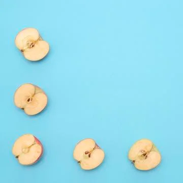Background of cut in half apples on blue background Stock Photos