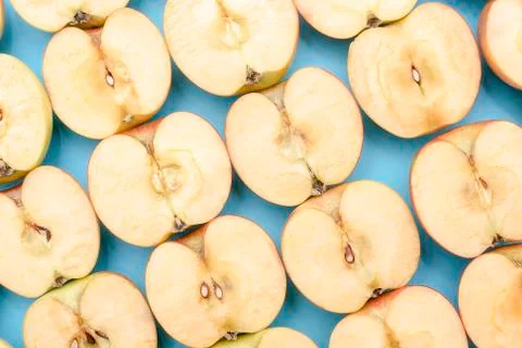 Background of cut in half apples on blue background Stock Photos