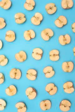 Background of cut in half apples on blue background Stock Photos
