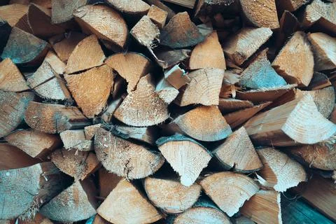 Background with cutted fire wood bricks for heating closeup. Stock Photos