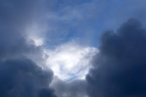 Background of dark clouds before a thunder-storm . Stock Photos