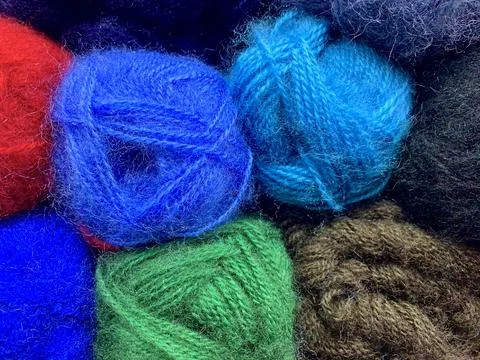 The background of dark colors of woolen downs yarns are tightly stacked in the Stock Photos