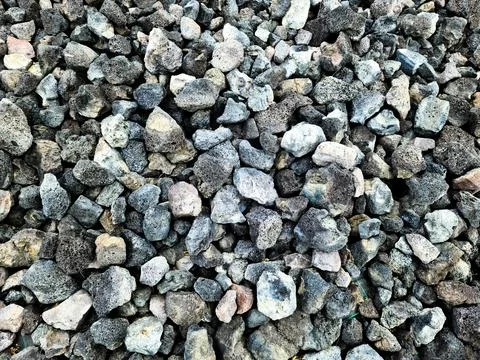 Background of dark gray and light gray lava rocks forming a natural texture Stock Photos