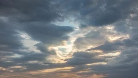 Background with dark thunderstorm clouds at sunset Stock Photos