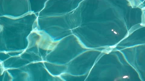 Background of dark turquoise water surface in swimming pool with sun reflection Stock Footage 204006060
