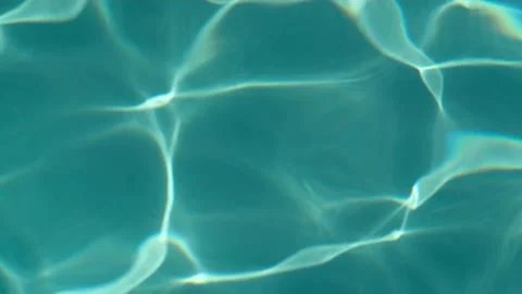 Background of dark turquoise water surface of swimming pool with sun reflections Video stock 219231988