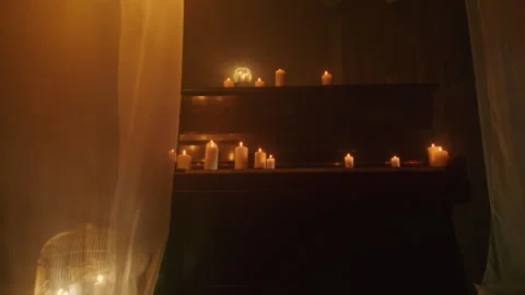 In a background of darkness, a witch performs a mystic rite with black candles Stock Footage 244434044