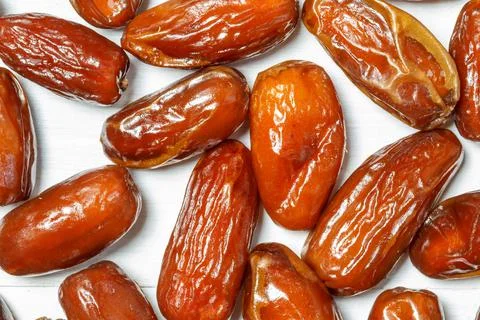 Background with dates in close-up. Wallpaper with dried fruits Stock Photos