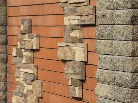 The background is a decorative brick wall, the focus is in the foreground. Te Stock Photos
