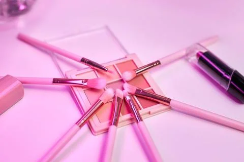 Background with decorative cosmetics on dressing table in makeup room Stock Photos