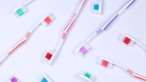 Background dental toothbrushes of different colors on a white background top Stock Footage 229796869