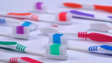 Background dental toothbrushes of different colors on a white background top Stock Footage 243256576