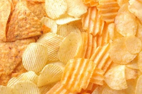 Background from different chips close-up. Snacks. unhealthy food. Stock Photos
