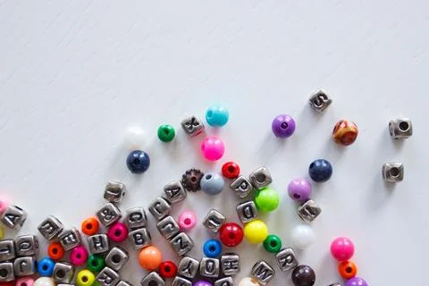 Background from different colored beads with numbers and symbols, flat lay 库存照片