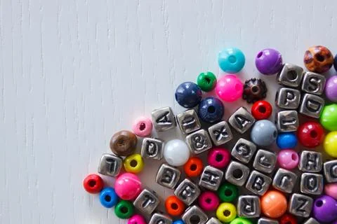 Background from different colored beads with numbers and symbols Foto stock