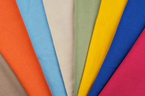 Background of different colors of fabric. Material for sewing. Stock Photos
