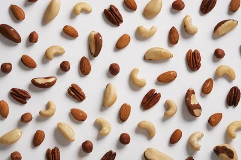 Background of different nuts on a white backdrop. Almonds, cashews, hazelnu.. Stock Photos
