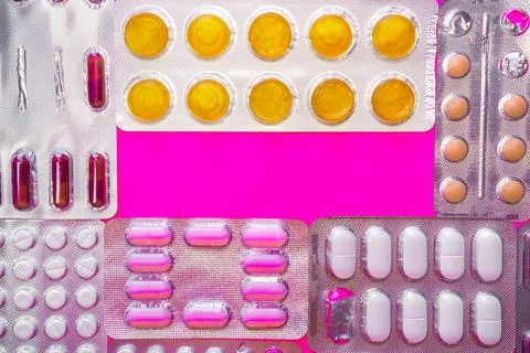 Background of different pill blisters with copy space in the center Stock Photos