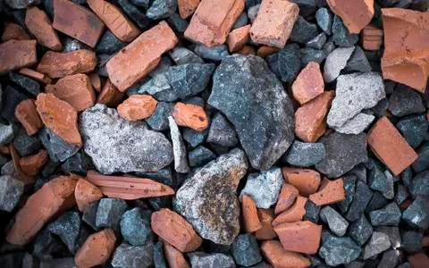 Background with different size and colour rocks and bricks on the ground Stock Photos