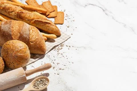 Background with different types of fresh bread. Bakery products. Cooking. Stock Photos