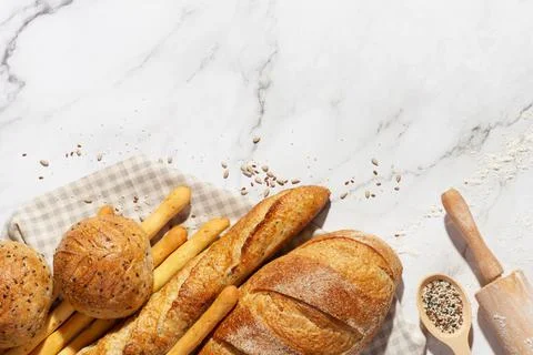 Background with different types of fresh bread. Bakery products. Cooking. Stock Photos