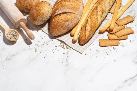 Background with different types of fresh bread. Bakery products. Cooking. Stock Photos