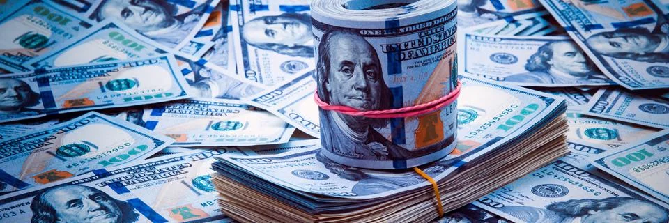 Background from dollars. Notes of one hundred American dollars are scattered  Stock Photos