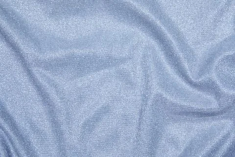 Background of draped light blue fabric with silver lurex thread Stock Photos