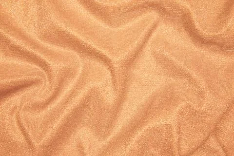 Background of draped light orange fabric with silver lurex thread Stock Photos
