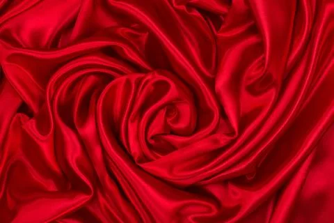 Background of draped red silk fabric. Creases and creases in the fabric. Conc Stock Photos