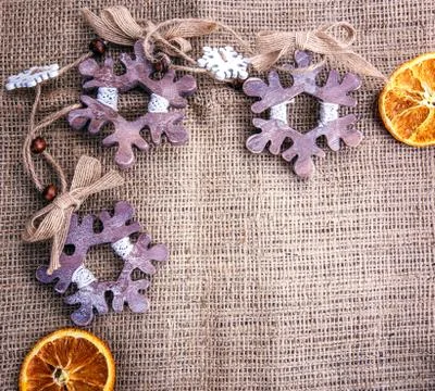 Background dried apple Orange burlap snowflake Stock Photos