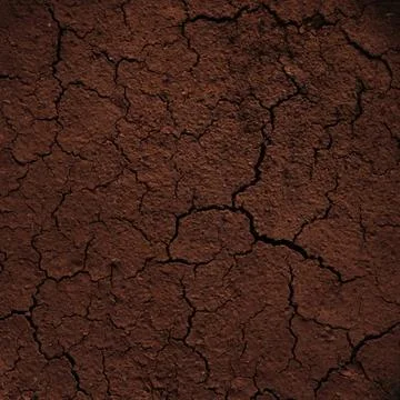 Background of dried brown coffee grounds cracked from the heat Stock Photos