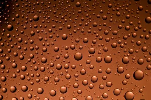 Background from drops of the different size on red glass with the vignette Foto stock