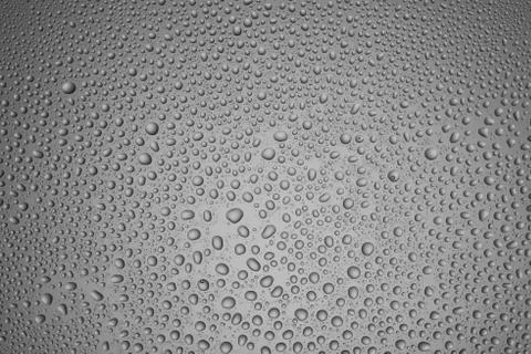 Background from drops of different size on steel-color glass Stock Photos