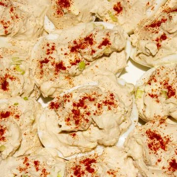 Background of eggs stuffed with cod liver top view. Stock Photos