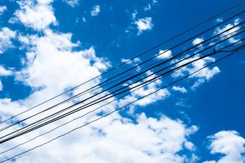 The background of electrical wire cable with blue sky for energy power consum Stock Photos