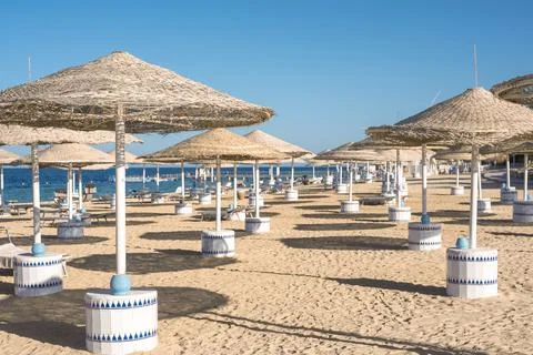 Background of empty beach resort or hotel, beach umbrellas clean light sand,  Stock Photos