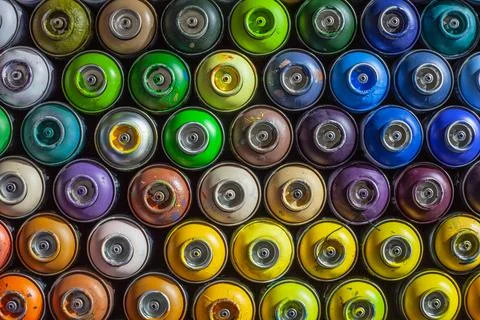 Background of empty cans of paint for graffiti. Tools for street art Stock Photos
