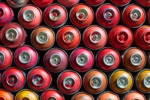 Background of empty cans of paint for graffiti. Tools for street art Stock Photos