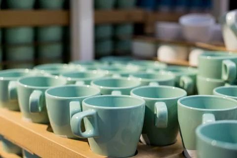 Background of empty ceramic cups.White and blue cups on the shelves in the store Stock Photos