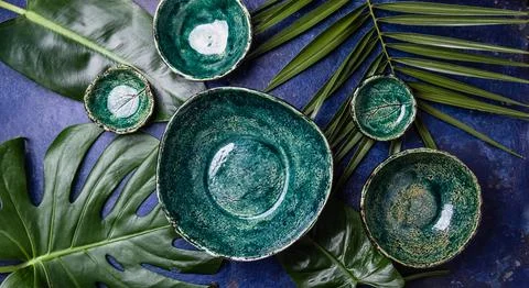 Background with empty green plates over tropical palm tree leaves and monstera Stock Photos