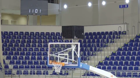 Background of empty seats and basketball hoop in a basketball arena Stock Footage
