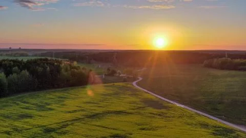 Background evening landscape. Field in the setting sun. Stock Photos