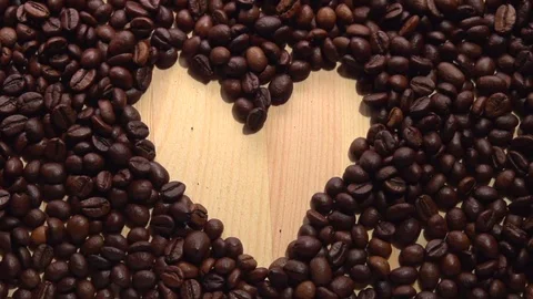 Background of falling coffee beans. Heart of the coffee beans. Stockbeeldmateriaal 71329039