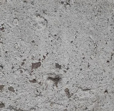 Background featuring the texture of an aged concrete wall. Close-up. Stock Photos