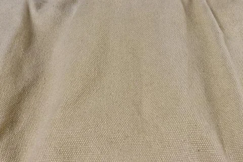The background is filled in the form of uneven coarse weave fabric. Stock Photos
