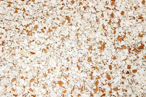Background of Finely crushed eggshells of different colors close-up. Foto stock