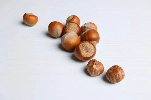 Background for food with hazelnuts, hazelnuts on a light wooden table. Soft f Stock Photos