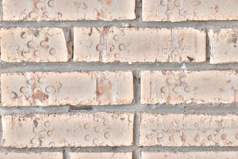 Background in the form of brickwork with round dents. The texture of the old  Stock Photos